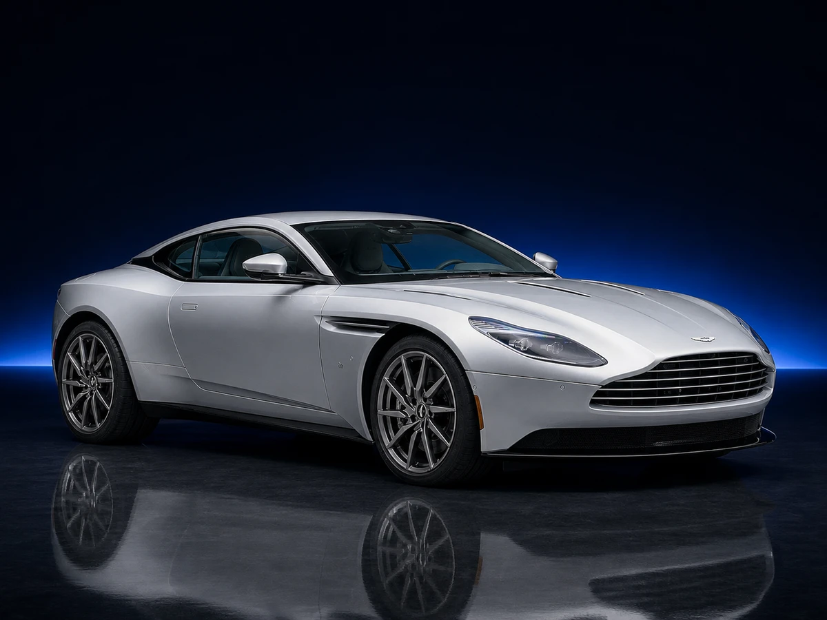 Silver Aston Martin DB11 V12 coupé on a deep navy and cobalt studio background.