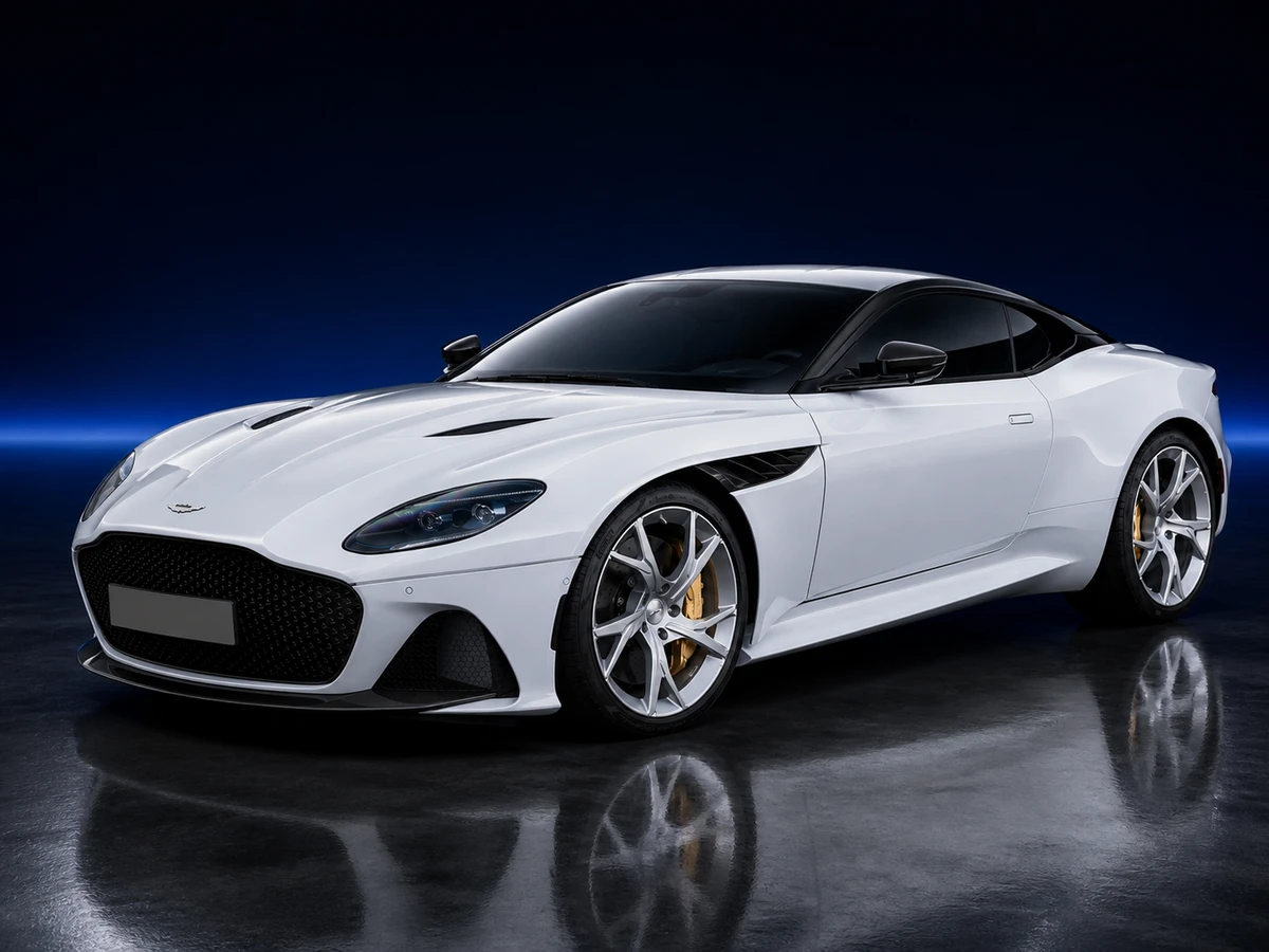 White Aston Martin DBS Superleggera coupé on a deep navy and cobalt studio background.