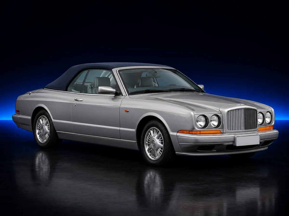 Silver Bentley Azure convertible on a deep navy and cobalt studio background.