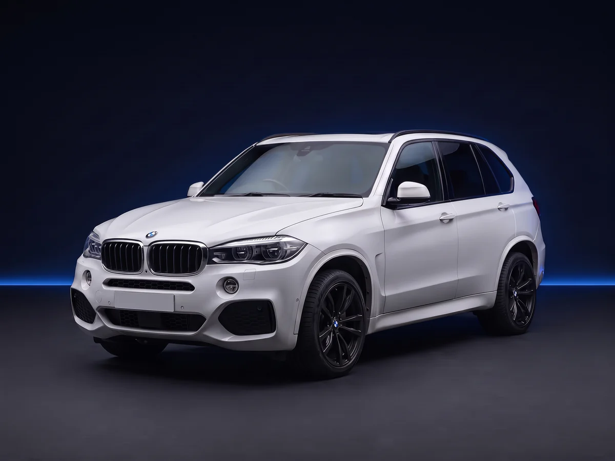 White BMW X5 F15 on a deep navy and cobalt studio background.