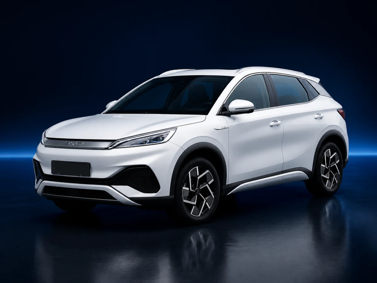 White first-generation BYD Atto 3 electric crossover on a deep navy and cobalt studio background.