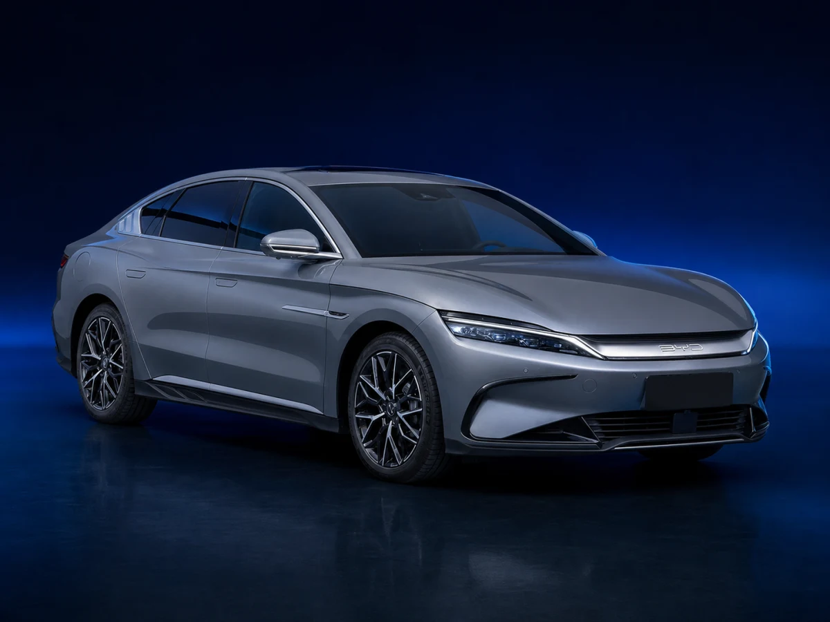 Graphite first-generation BYD Han electric executive saloon on a deep navy and cobalt studio background.