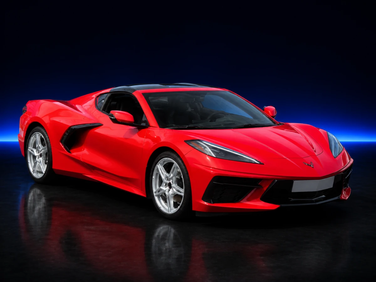 Red Chevrolet Corvette VIII C8 Stingray coupé on a deep navy and cobalt studio background.
