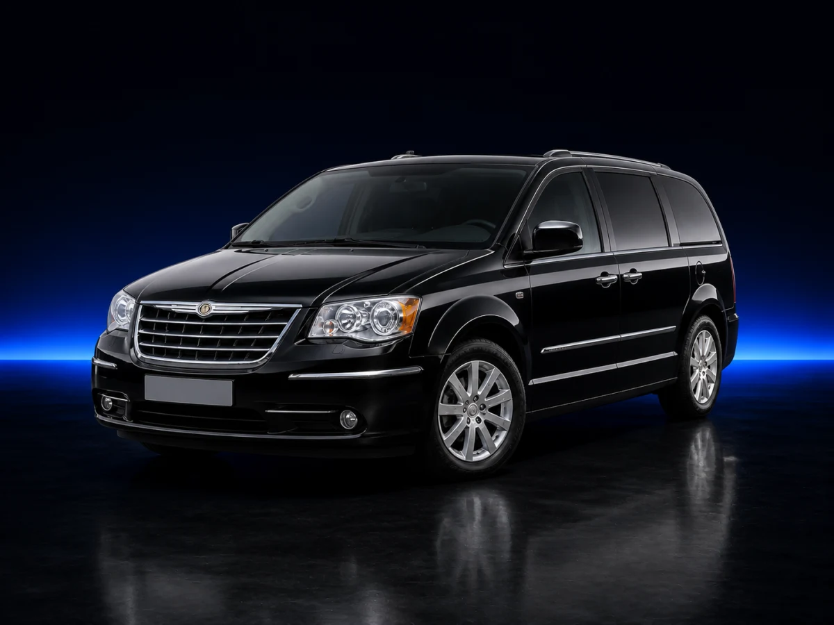 Black Chrysler Grand Voyager V RT long-wheelbase minivan on a deep navy and cobalt studio background.