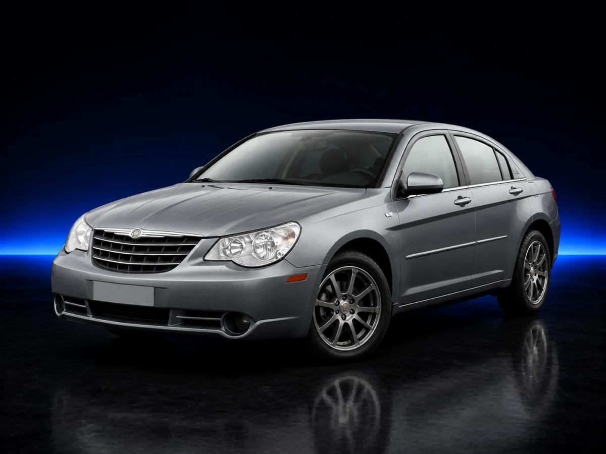 Silver Chrysler Sebring III JS saloon on a deep navy and cobalt studio background.