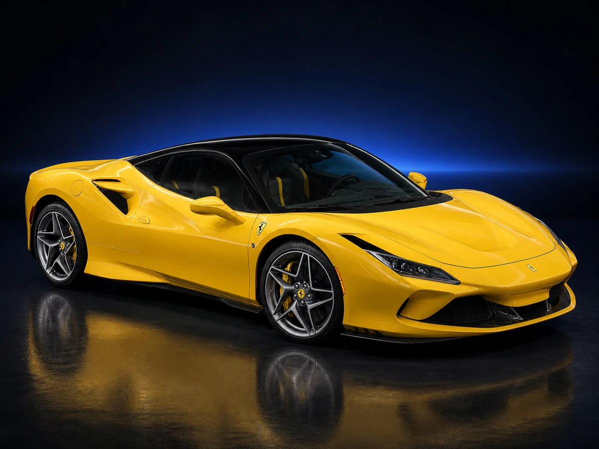 Yellow Ferrari F8 Tributo coupé on a deep navy and cobalt studio background.