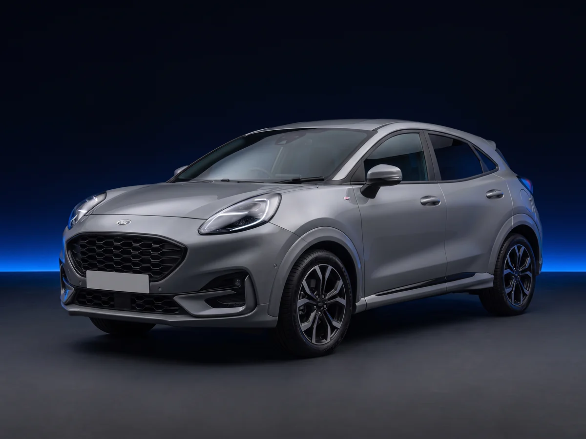 Grey second-generation Ford Puma ST-Line X on a deep navy and cobalt studio background.
