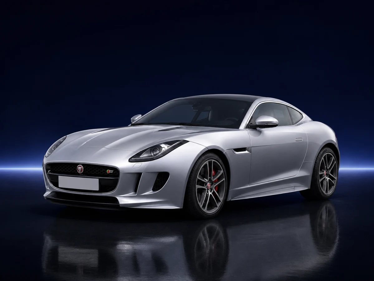 Silver Jaguar F-Type X152 coupe on a deep navy and cobalt studio background.