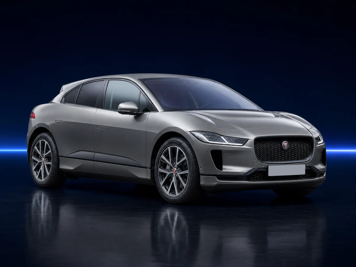 Silver Jaguar I-Pace X590 on a deep navy and cobalt studio background.