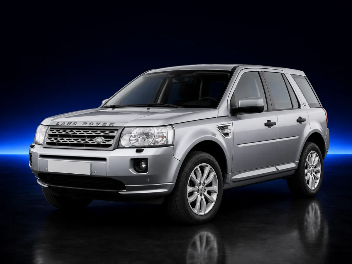 Silver Land Rover Freelander 2 L359 on a deep navy and cobalt studio background.