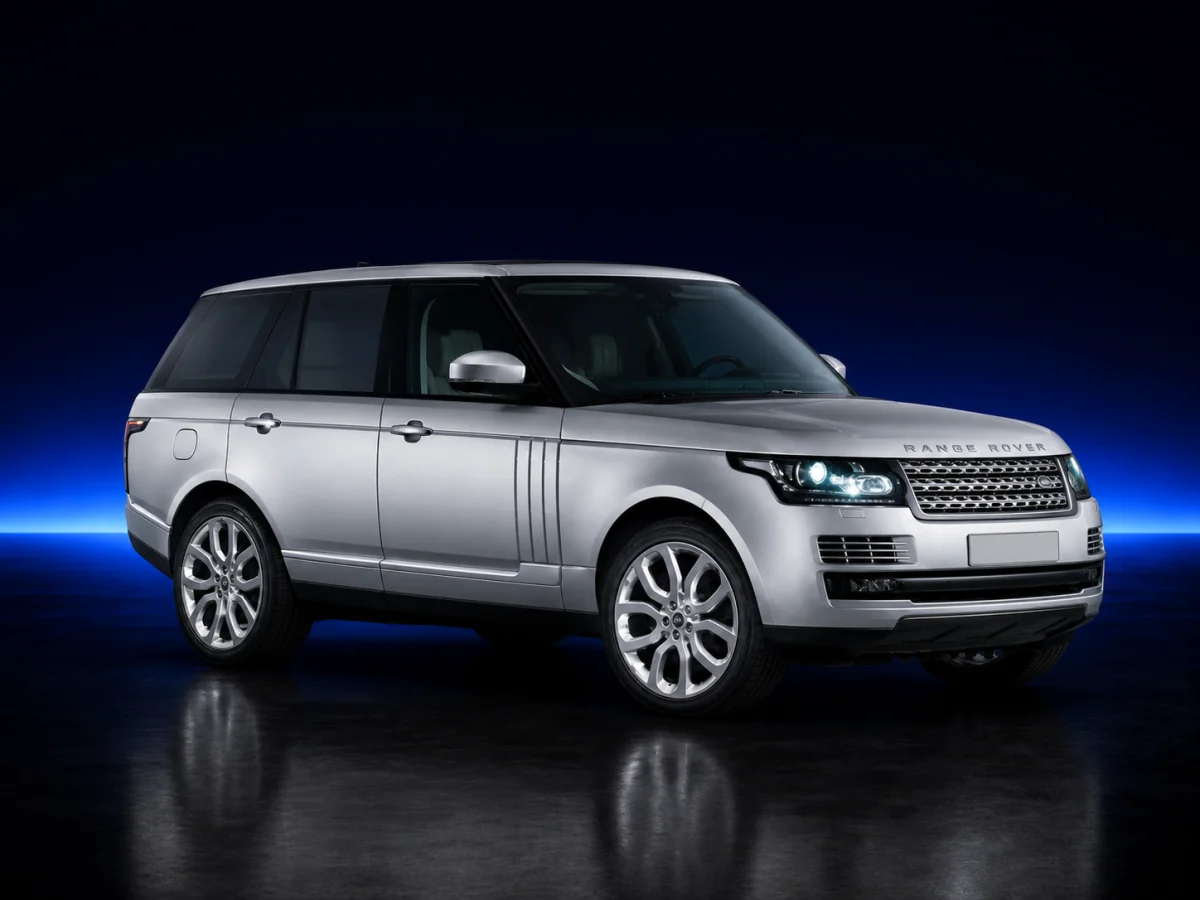Silver Land Rover Range Rover L405 on a deep navy and cobalt studio background.