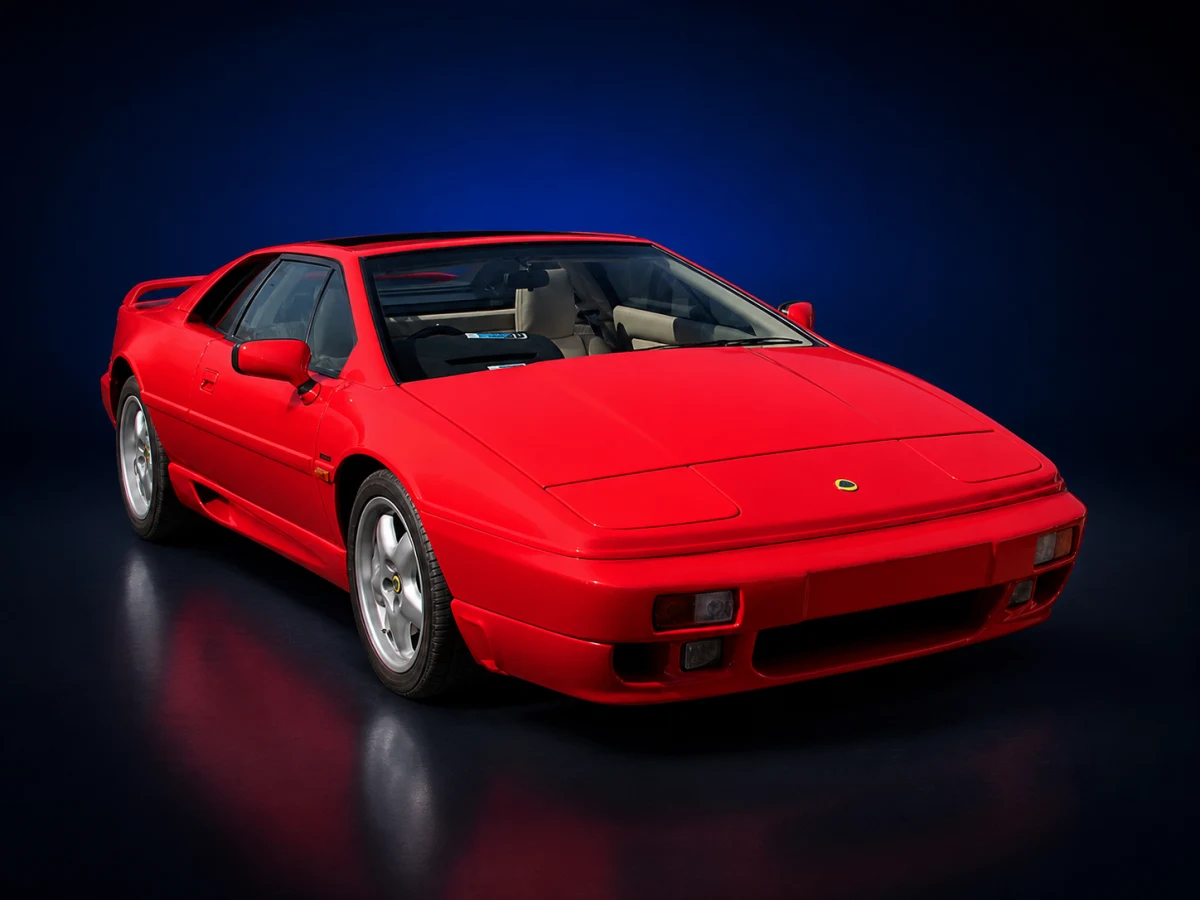 Red Lotus Esprit S4/GT3 coupé on a deep navy and cobalt studio background.
