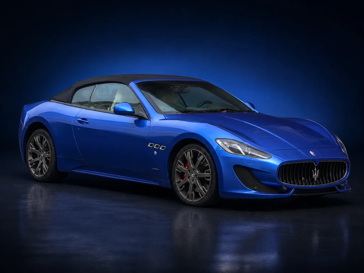 Blue Maserati GranCabrio M145 Sport convertible on a deep navy and cobalt studio background.