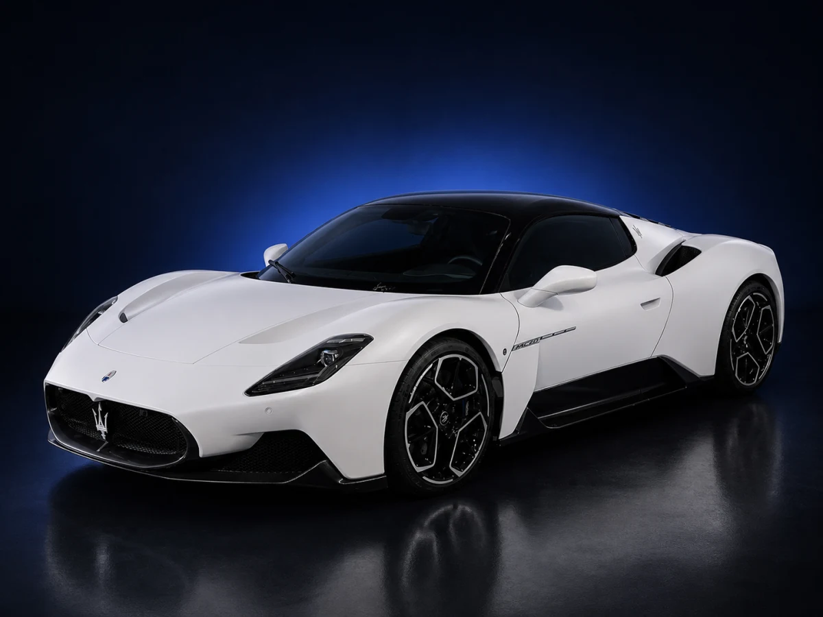 White Maserati MC20 M240 coupé on a deep navy and cobalt studio background.