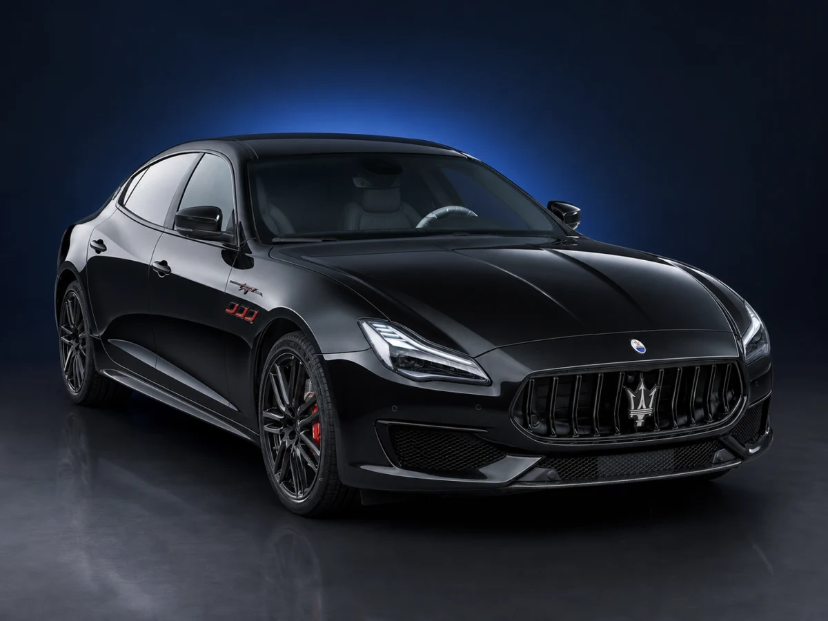 Black Maserati Quattroporte M156 Trofeo saloon on a deep navy and cobalt studio background.