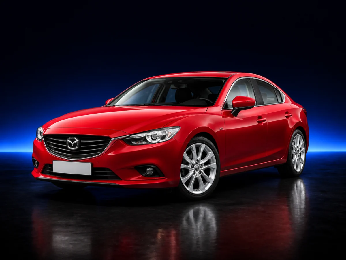 Red Mazda Mazda6 GJ saloon on a deep navy and cobalt studio background.