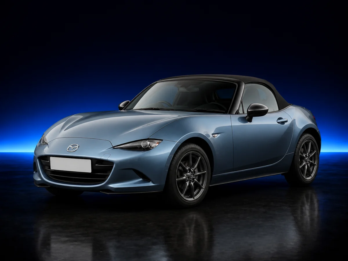 Blue-grey Mazda MX-5 ND on a deep navy and cobalt studio background.