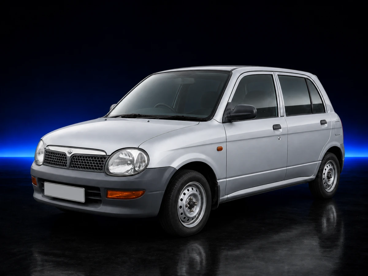 Silver Perodua Kelisa I L700 EX five-door hatchback on a deep navy and cobalt studio background.