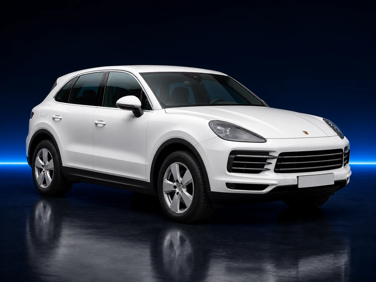 White Porsche Cayenne 9YA on a deep navy and cobalt studio background.