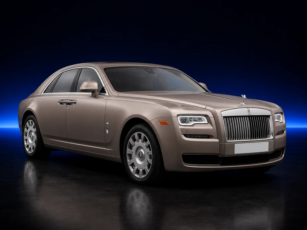 Silver Rolls-Royce Ghost on a deep navy and cobalt studio background.