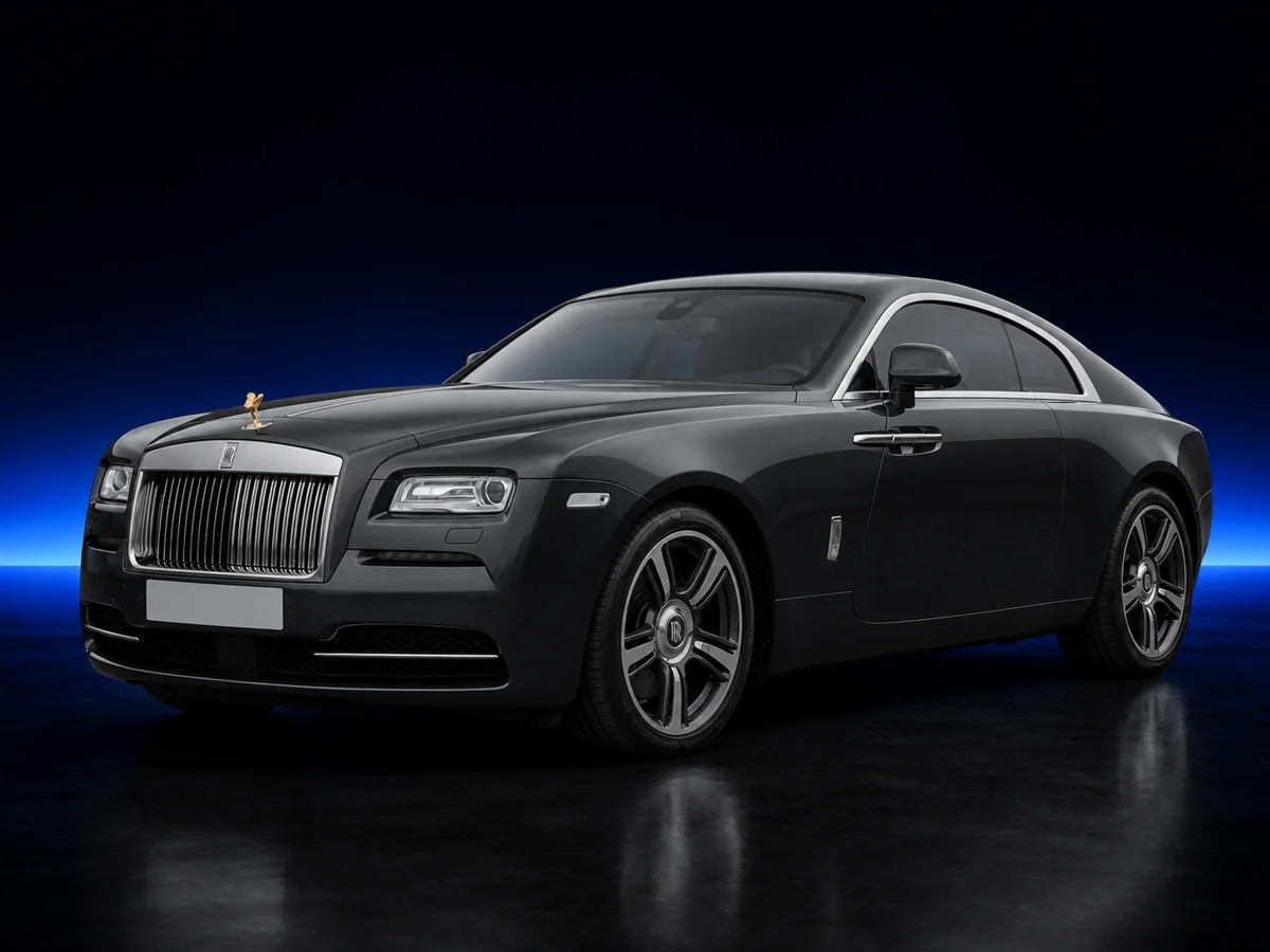 Dark grey Rolls-Royce Wraith on a deep navy and cobalt studio background.