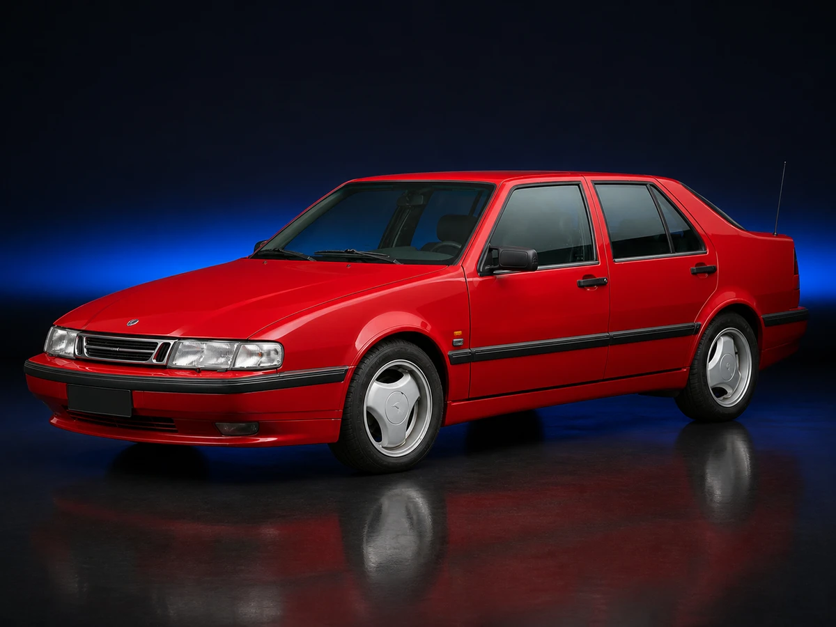 Red Saab 9000 CS Aero liftback on a deep navy and cobalt studio background.