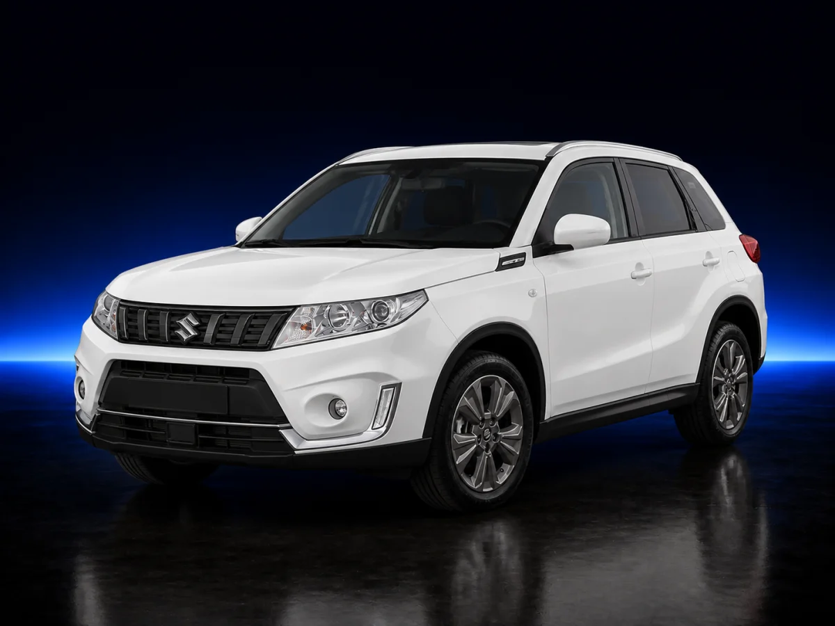 White Suzuki Vitara fourth-generation facelift on a deep navy and cobalt studio background.