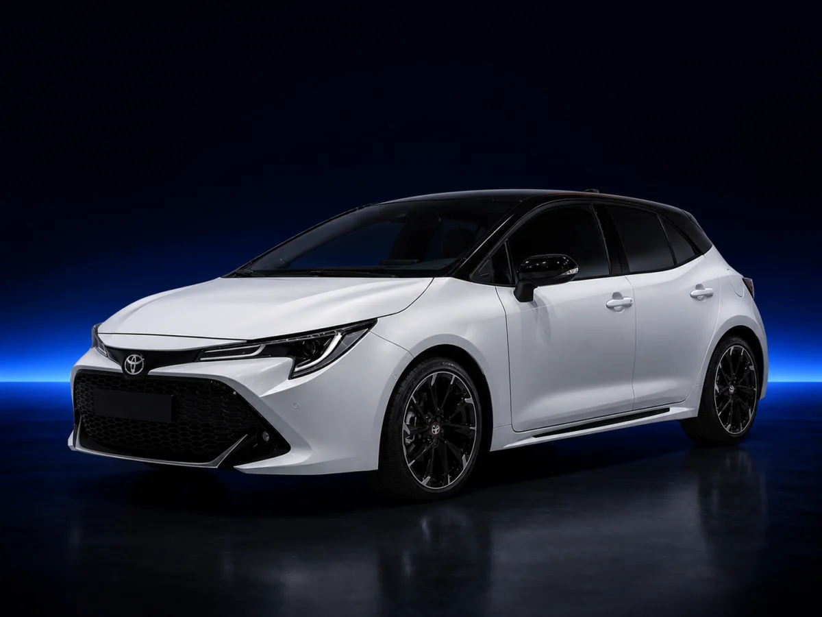White Toyota Corolla E210 GR Sport Hybrid on a deep navy and cobalt studio background.