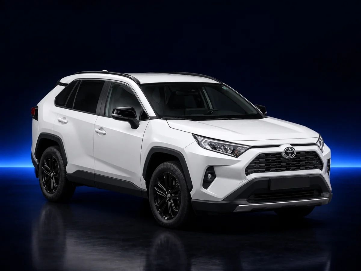 White Toyota RAV4 XA50 Hybrid on a deep navy and cobalt studio background.