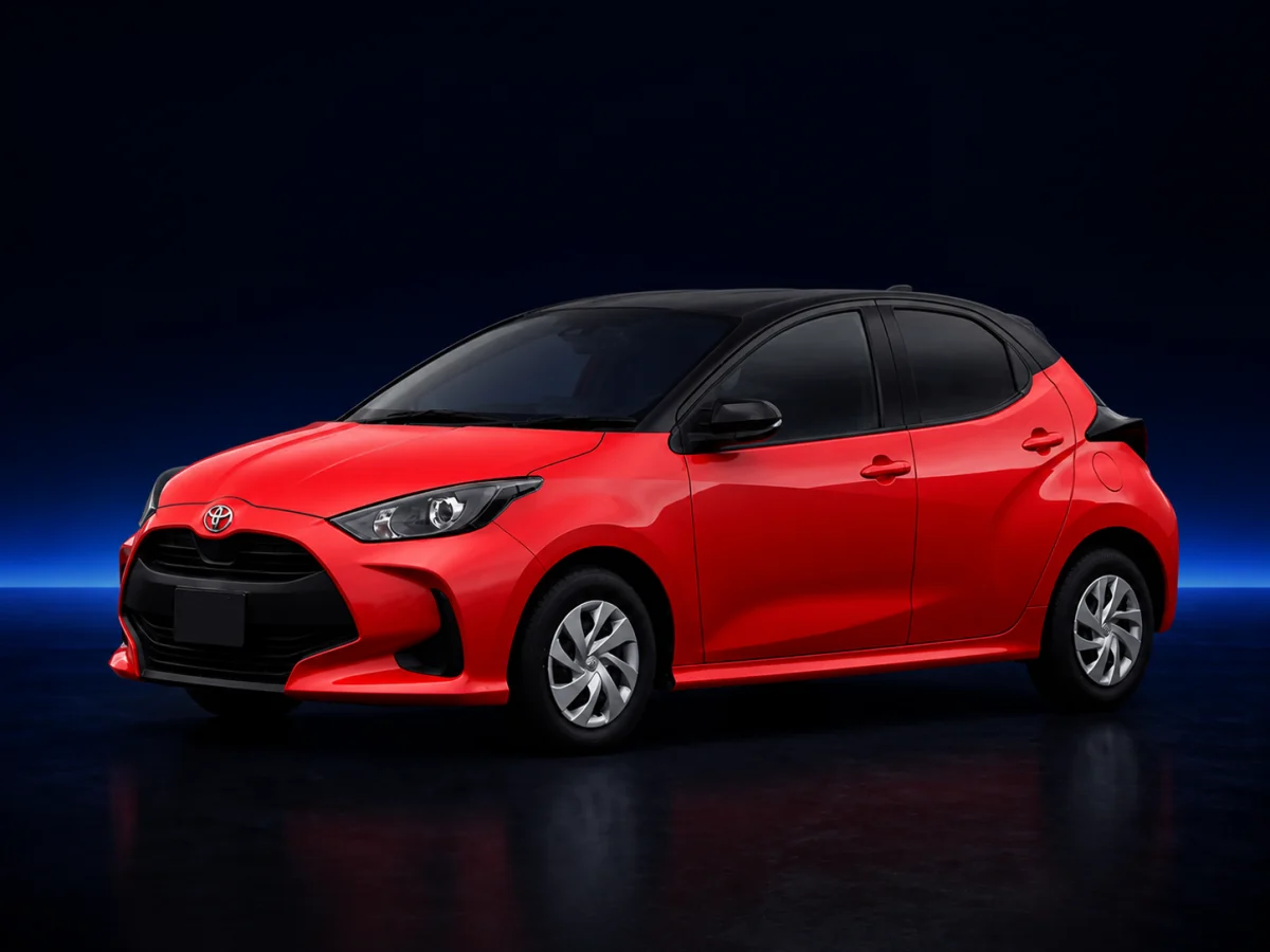 Red Toyota Yaris XP210 on a deep navy and cobalt studio background.