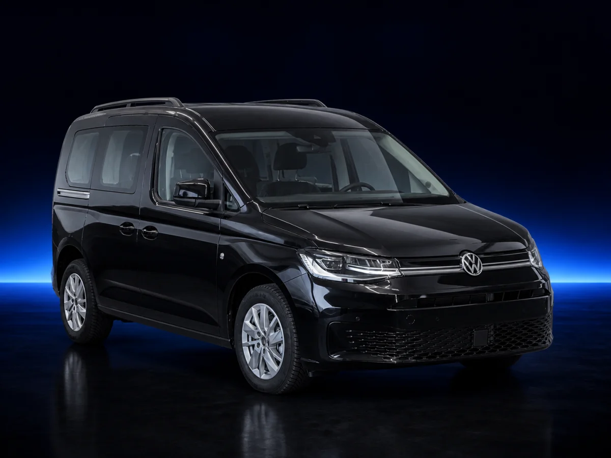 Black Volkswagen Caddy V passenger van on a deep navy and cobalt studio background.