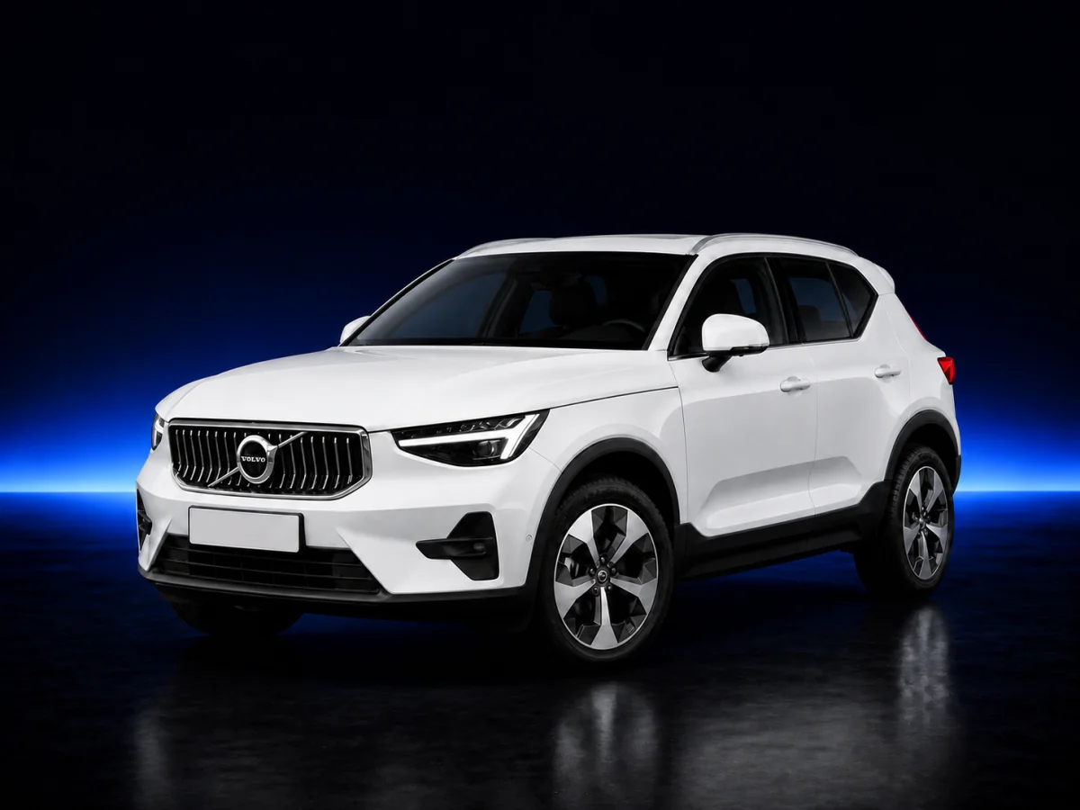 White Volvo XC40 on a deep navy and cobalt studio background.